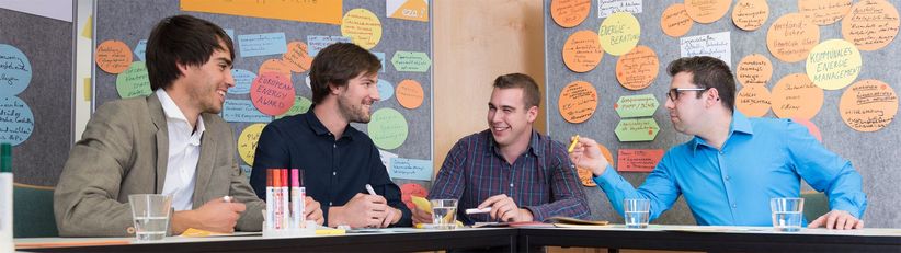 eza!-Klimaschutz Auf dem Bild zu sehen sind vier Personen, darunter eza!-Mitarbeiter Sebastian Hartmann, die gerade über neue Projekte für den Klimaschutz beraten.