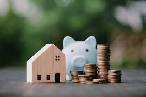 © Anawat_s-istockphoto Das Foto zeigt Geldmünzen und ein Modellhäuschen